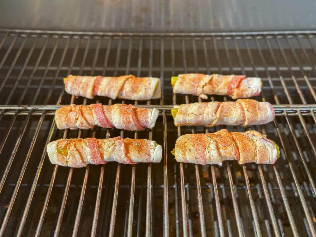 Bacon wrapped pickles on the smoker