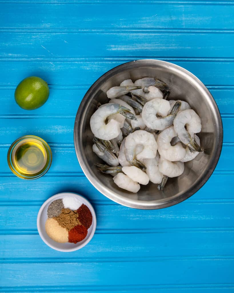 Raw shrimp in a bowl getting ready to marinate 