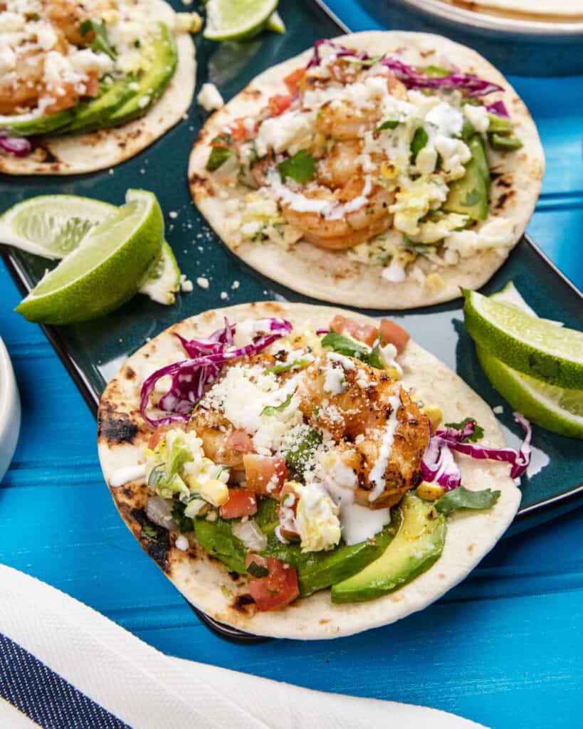 Grilled Baja shrimp tacos with avocados, cotija cheese, cabbage and corn. 
