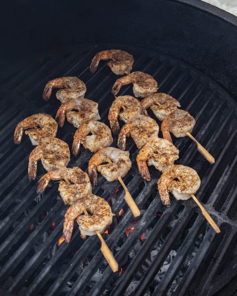 Shrimp on skewers being grilled