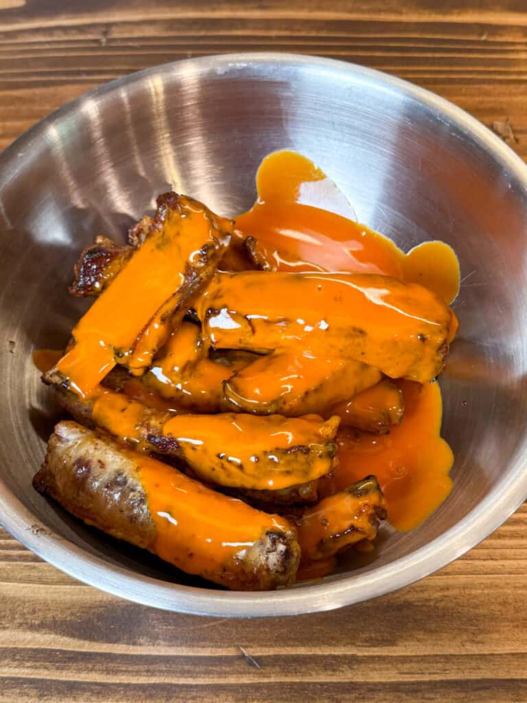 Pork spare ribs covered in buffalo sauce