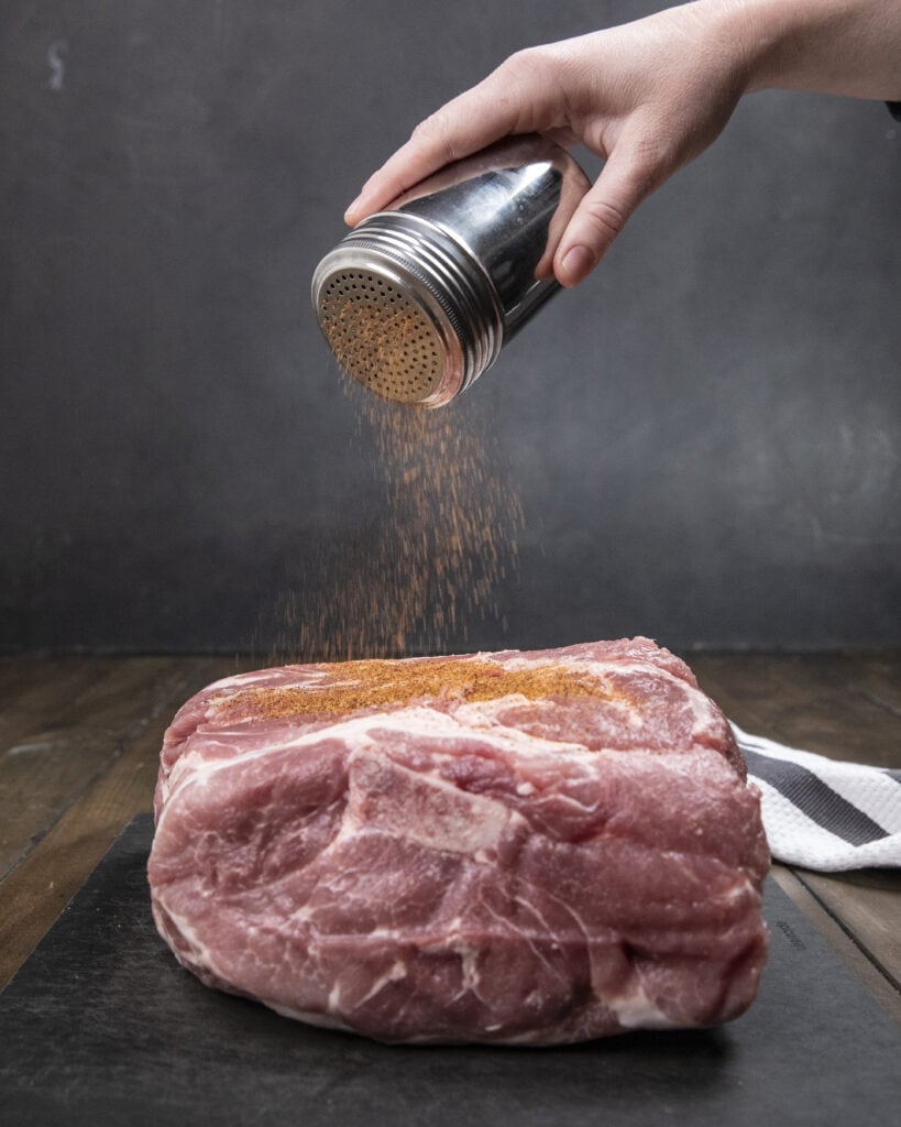 Seasoning a pork butt